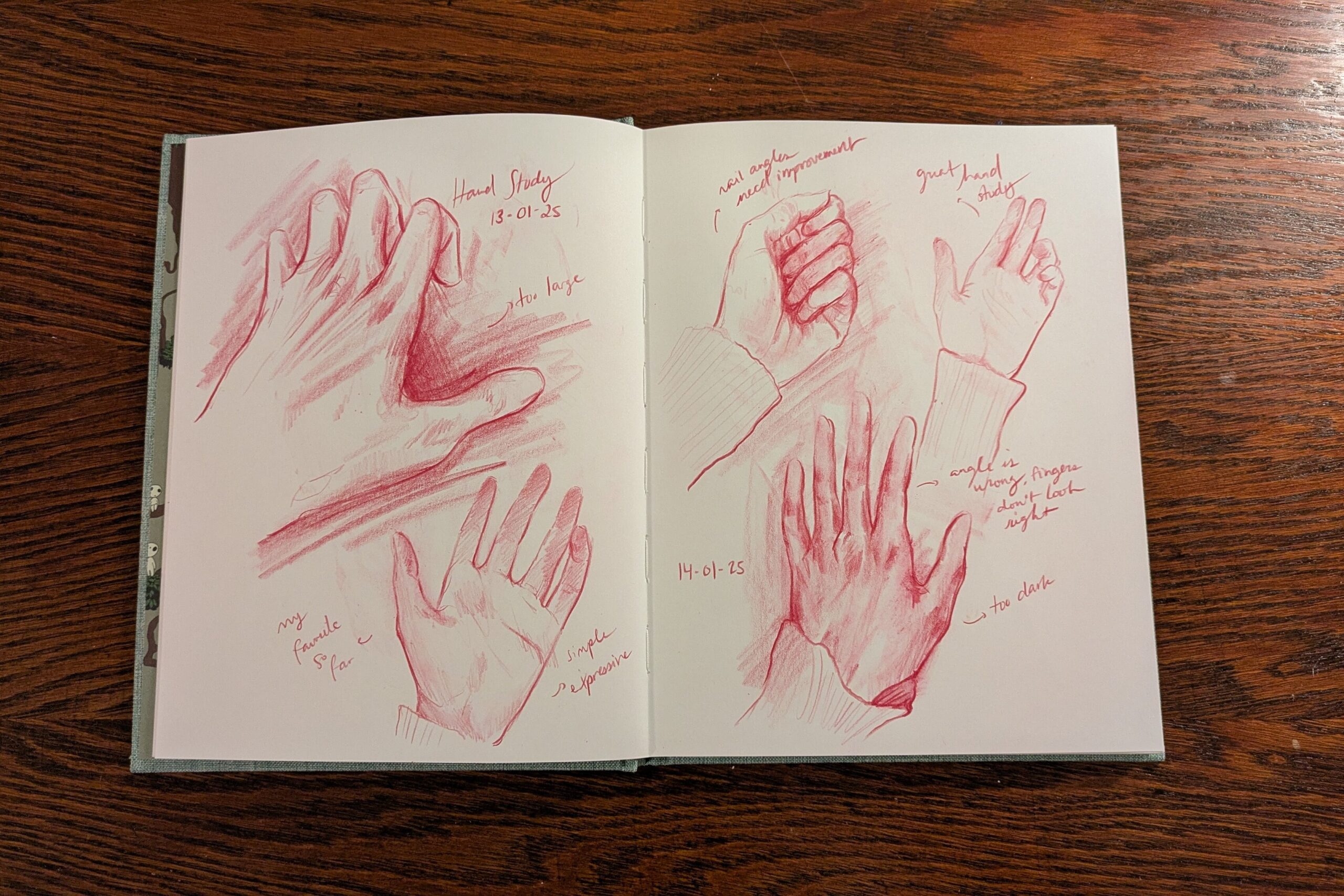 Hand studies made by Emi with red pencil on paper in a sketchbook.